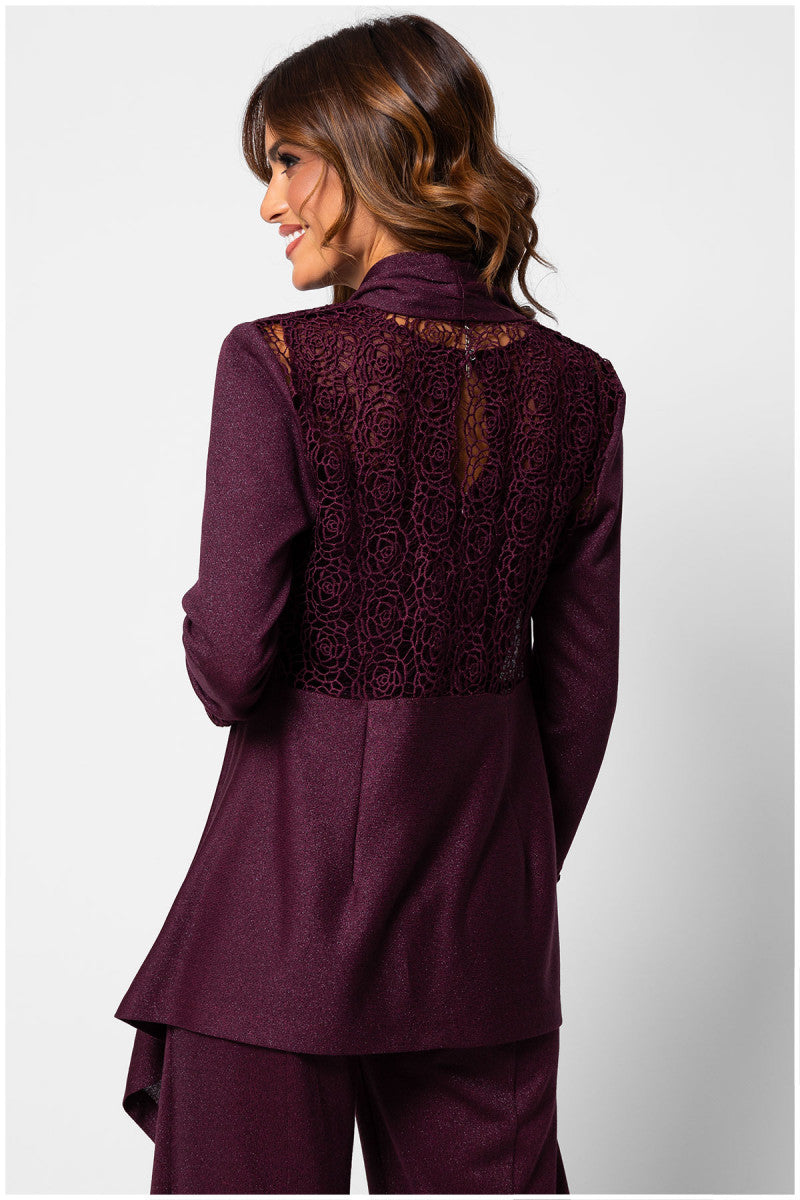 Woman wearing a burgundy outfit with lace detailing on a white background