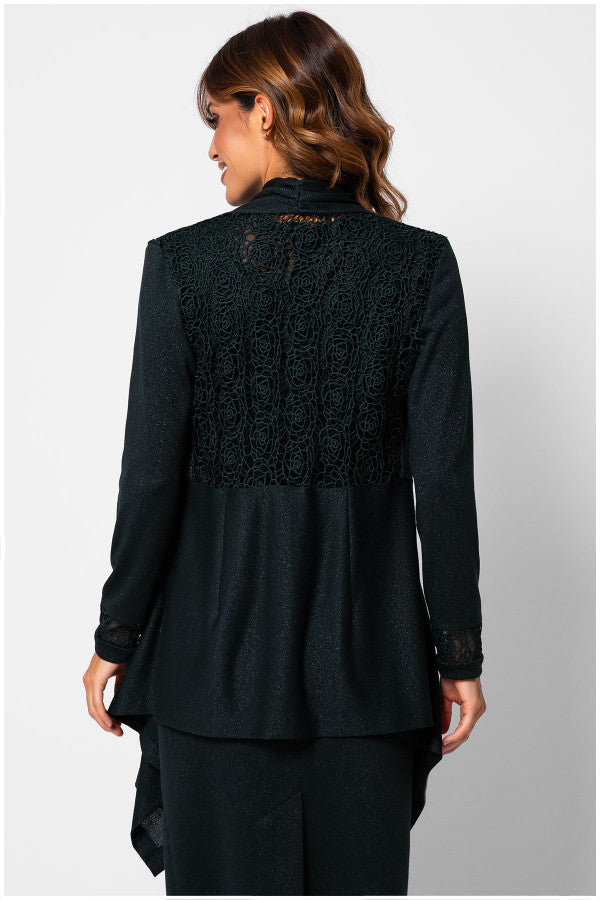 Woman wearing a black lace top and black pants on a light gray background Luna Fashion House