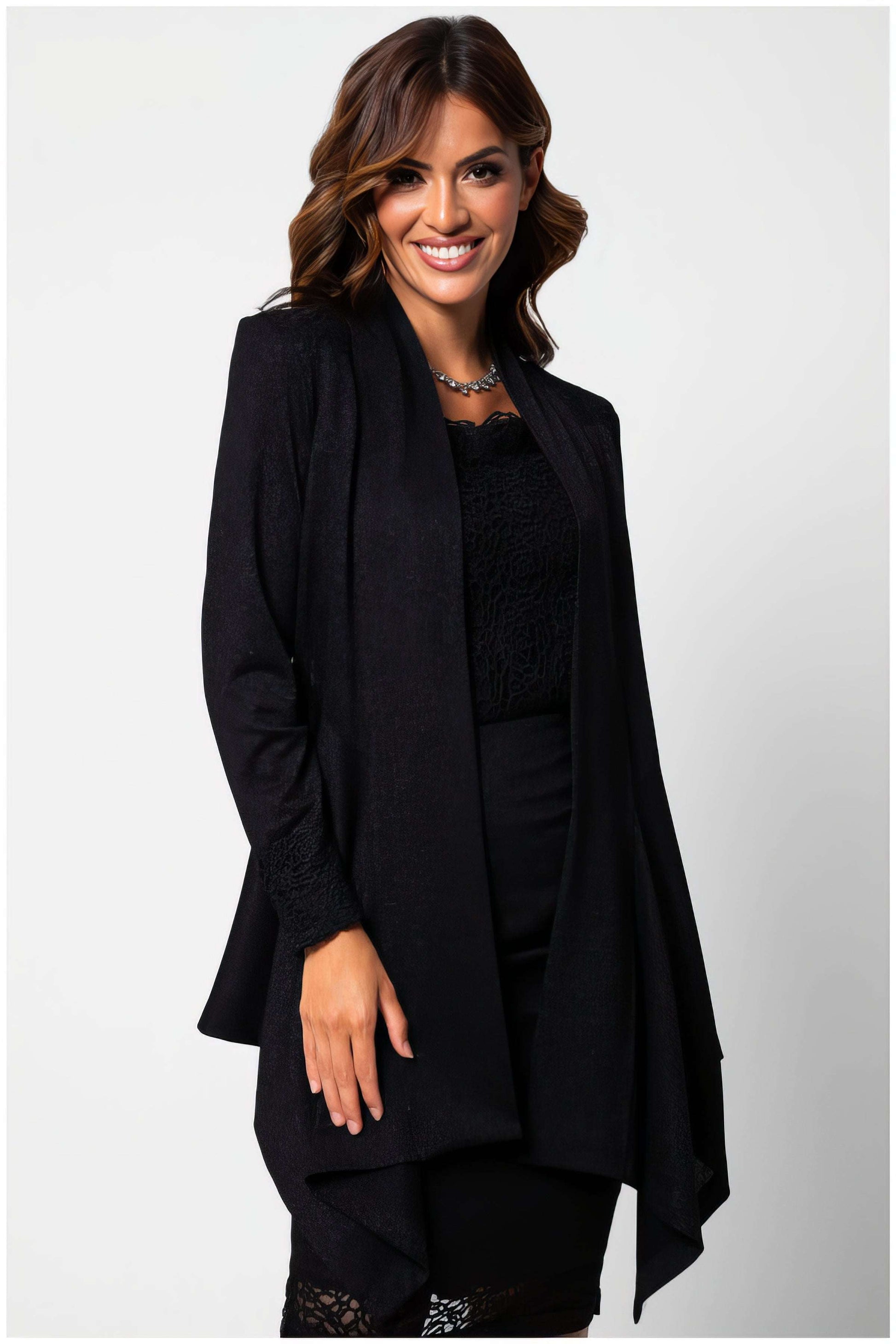 Woman wearing Jody Lace Cardigan in Black with long sleeves styled elegantly against white background