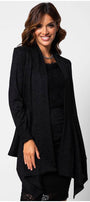Woman wearing elegant black lace Cardigan Jody with lace trim, featuring a draped open front and sophisticated style