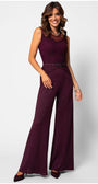 Woman wearing elegant Bordeaux lace Lace Overalls with wide-leg trousers and tonal belt, smiling against white background