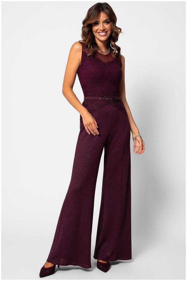 Woman wearing elegant Bordeaux lace Lace Overalls with wide-leg trousers and tonal belt, smiling against white background