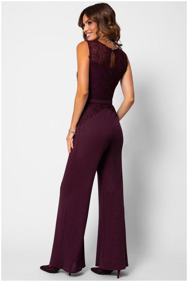 Woman wearing Lace Overalls in Bordeaux jumpsuit with wide-leg trousers and tonal belt, posing with back to camera