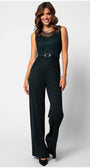 Woman wearing a midnight green Lace Overalls fitted bodice jumpsuit with wide-leg trousers and matching belt, smiling confidently.