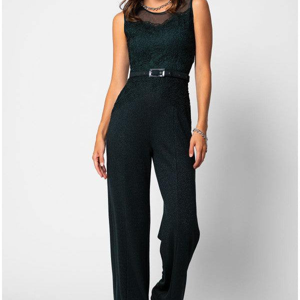 Woman wearing a midnight green Lace Overalls fitted bodice jumpsuit with wide-leg trousers and matching belt, smiling confidently.