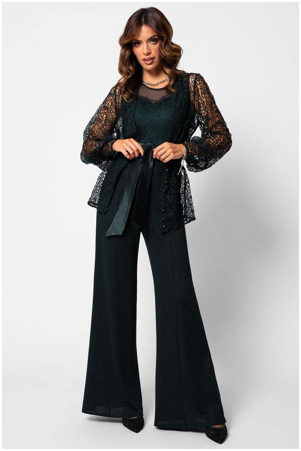 Woman wearing a Midnight Green lace bodice Lace Overalls with sheer sleeves and wide-leg trousers, styled with a matching belt.