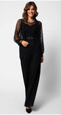 Woman wearing the Lace Overalls Jody Noir black lace bodice jumpsuit with wide-leg trousers and a tonal belt.