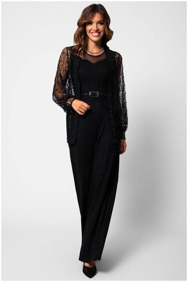 Woman wearing the Lace Overalls Jody Noir black lace bodice jumpsuit with wide-leg trousers and a tonal belt.