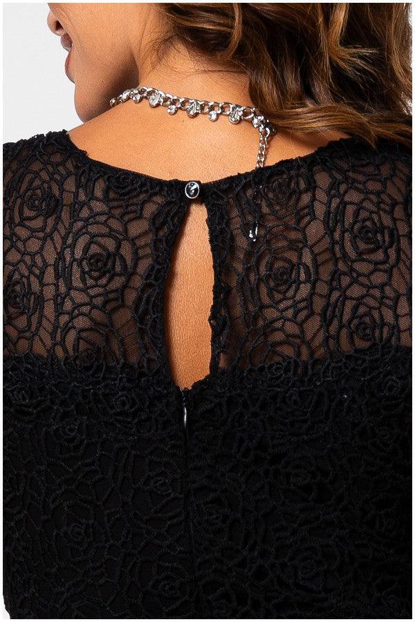 Close-up of the black Lace Overalls with sheer floral detailing and button closure on the OVERALL JODY jumpsuit back.