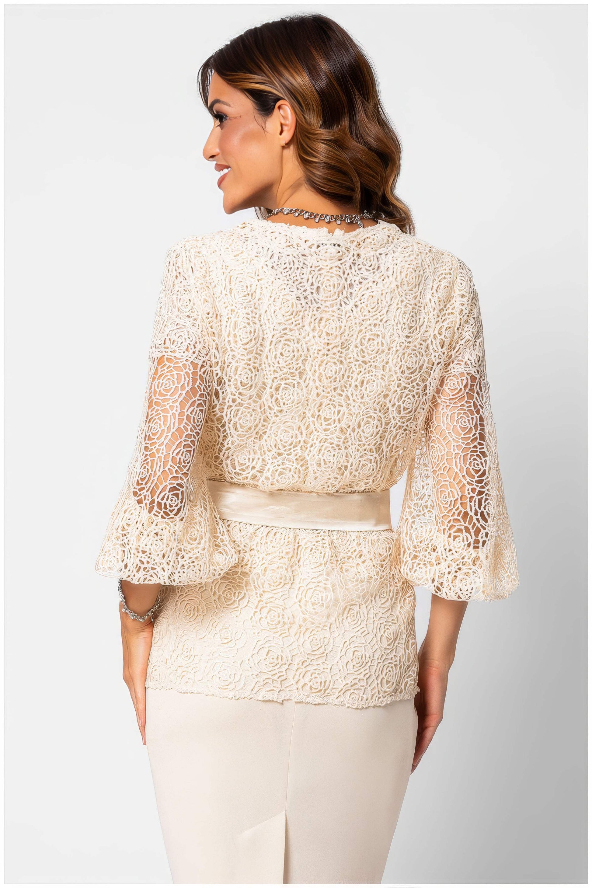 Back view of a woman wearing Jody Lace Belted Sweater in Ivory with intricate lace design and flared sleeves.