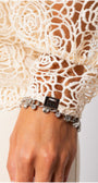 Close-up of intricate lace cuff detail with charms on Jody Lace Belted Sweater in Ivory by Luna Fashion House