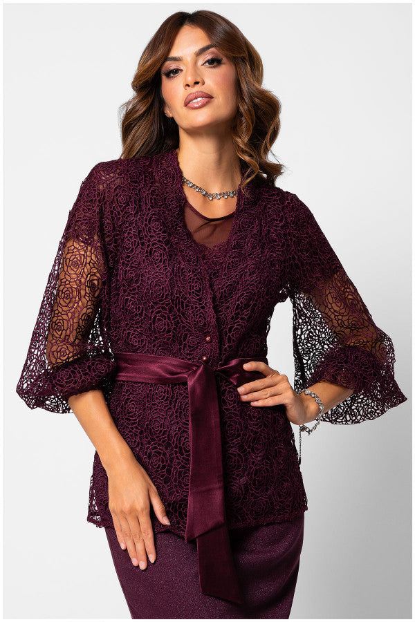 Woman wearing bordeaux lace elegant sweater Jody with belted waist and sheer floral sleeves, styled elegantly for day or evening.