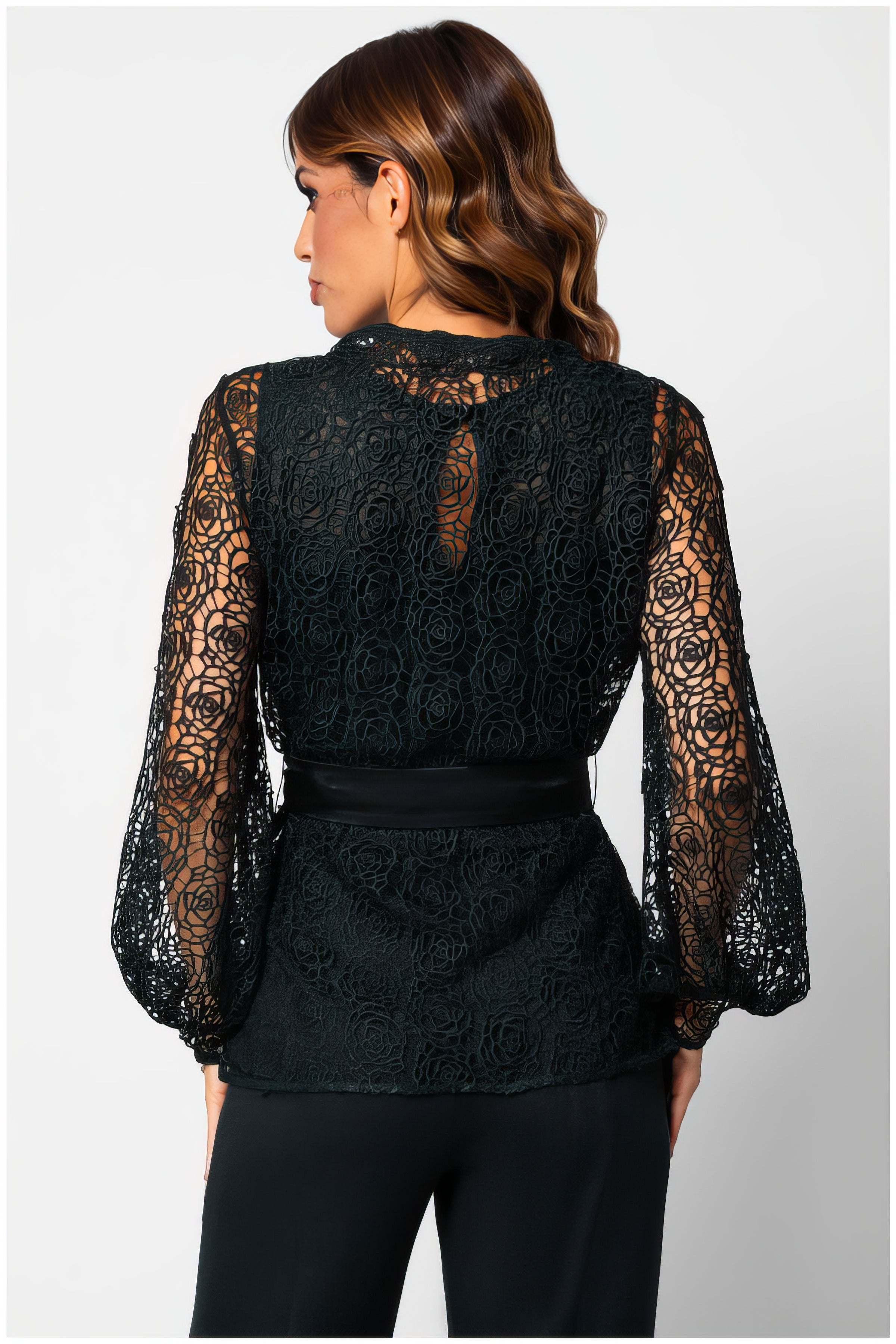 Woman wearing Jody Lace Belted Sweater in Midnight Green with intricate lace details and a belted waist, shown from the back.