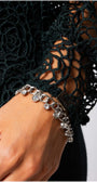 Close-up of intricate lace sleeve detail on Jody Lace Belted Sweater in Midnight Green showing delicate craftsmanship.