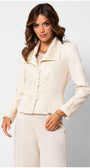 Woman wearing an ivory lace tailored blazer embroidered blazer with structured waist and matching tailored trousers against white background