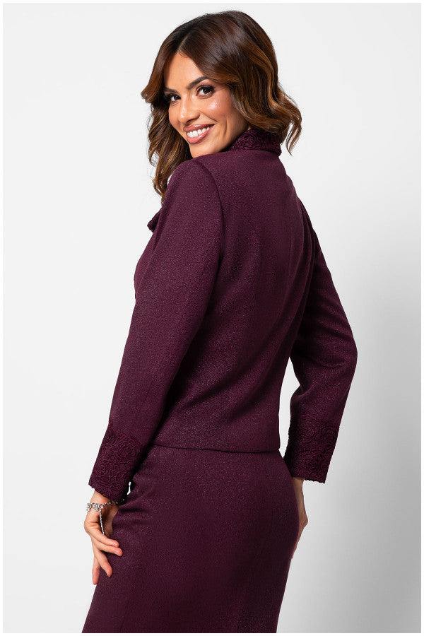 Woman wearing fitted Bordeaux lace  tailored blazer with embroidery on collar and cuffs, smiling over her shoulder