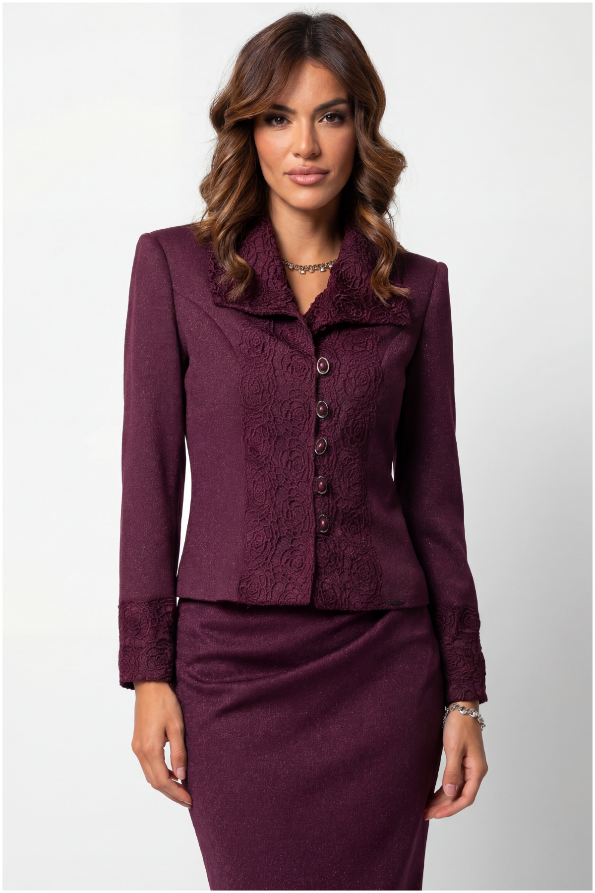 Woman wearing a burgundy suit with a white background