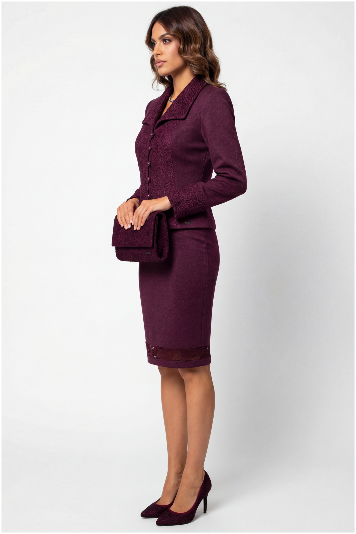 Woman wearing a purple suit with a white background