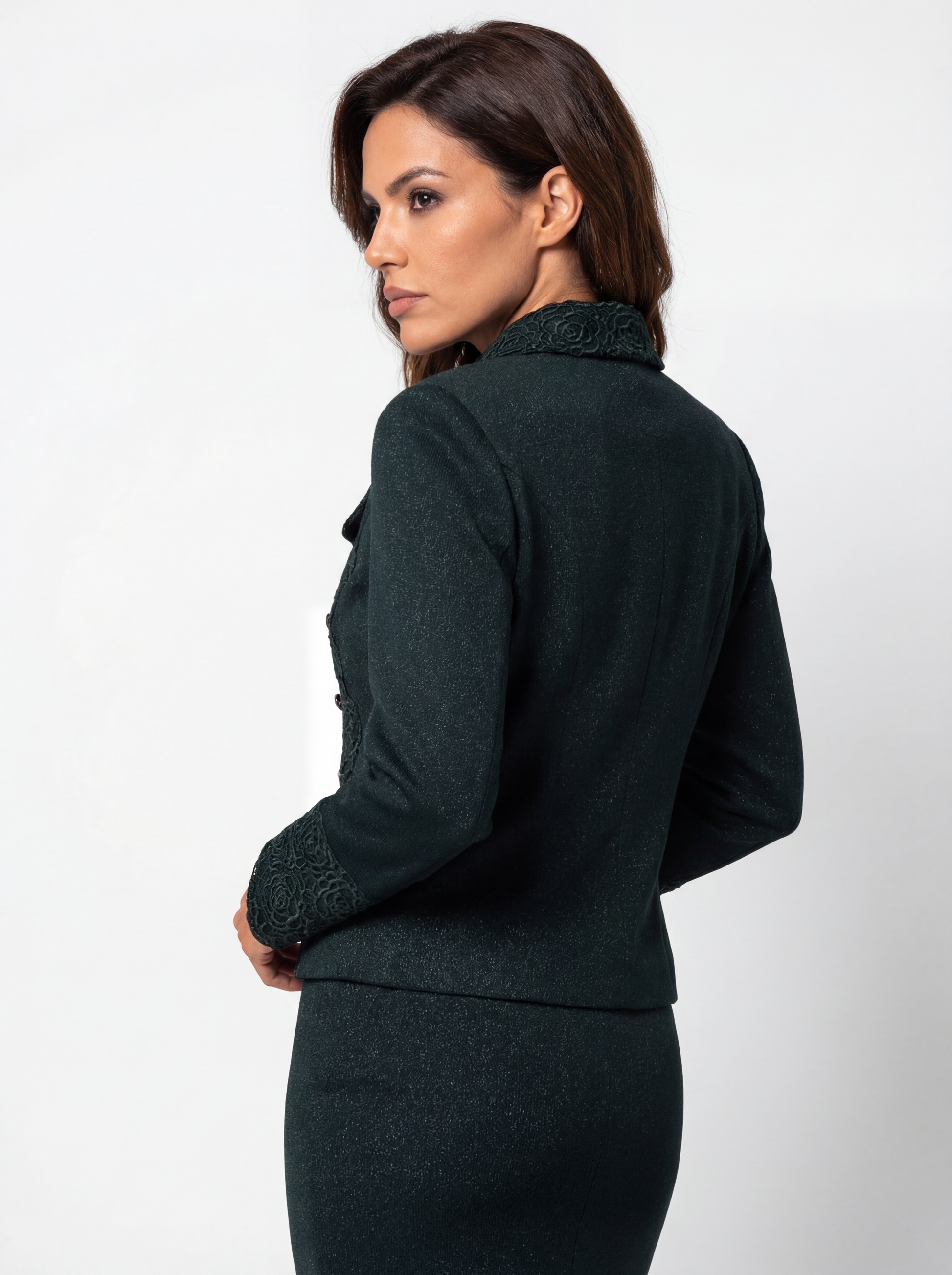 Woman wearing a dark green suit on a white background