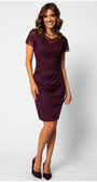 Burgundy Lace Cocktail Dress, Jody. Front view on the model, short lace sleeves and a draped skirt.