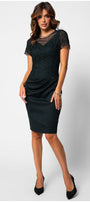 Woman wearing a fitted lace cocktail dress with short sleeves and tailored waist draping, styled for elegant occasions