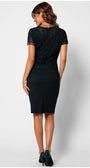 Woman wearing a fitted lace cocktail dress midnight green lace dress with short sleeves and a back slit, styled for evening elegance.