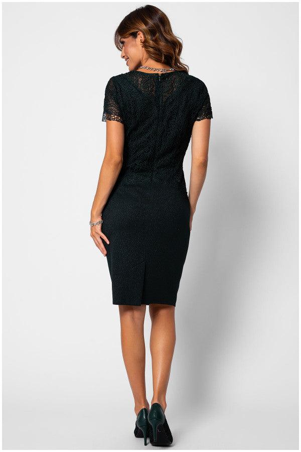 Woman wearing a fitted lace cocktail dress midnight green lace dress with short sleeves and a back slit, styled for evening elegance.
