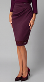 Person wearing a burgundy skirt with lace trim on a gray background