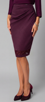 Person wearing a burgundy skirt with lace trim on a gray background