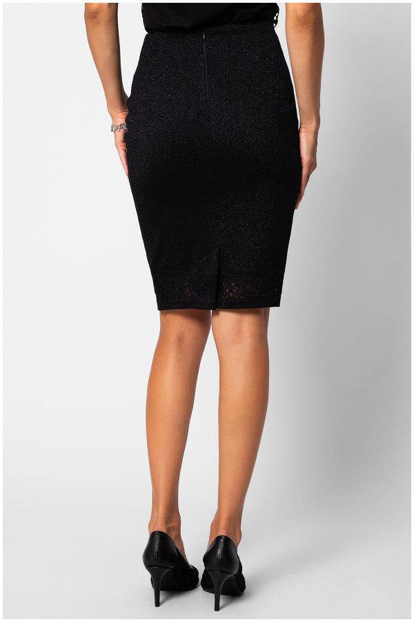 Back view of a woman wearing a fitted pencil skirt with a lace hem and a subtle slit at the back