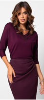 Woman wearing a bordeaux lace elegant blouse  Top Jody with lace neckline detail and three-quarter sleeves in a sophisticated styled pose