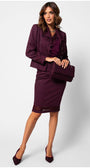 Woman wearing a bordeaux lace elegant blouse under blazer and skirt set with lace details, holding a matching handbag and wearing pointed heels.