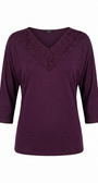 Purple blouse with lace neckline on a white background