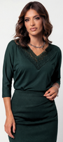 Woman wearing a green dress with lace neckline on a white background