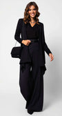 Woman wearing Agatha High Waisted Wide Leg Pants in Black styled with a black top, belt, and long jacket.