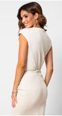 Back view of a woman wearing the sleeveless ivory lace elegant blouse Blouse Jody with a fitted skirt against a white background.