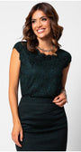 Woman wearinge legant blouse  a midnight green floral lace blouse with cap sleeves paired with a fitted dark skirt against a white background