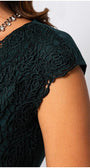 Close-up of elegant blouse Midnight Green blouse sleeve with intricate floral lace overlay and smooth fabric detail.