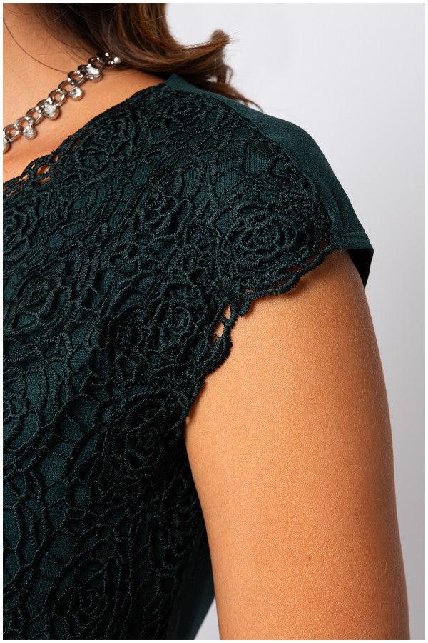 Close-up of elegant blouse Midnight Green blouse sleeve with intricate floral lace overlay and smooth fabric detail.