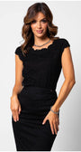 Woman wearing a black lace elegant blouse with cap sleeves paired with a fitted black skirt and silver jewelry.