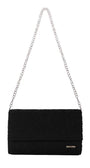 Black clutch bag with floral lace overlay and silver chain strap for versatile evening wear.