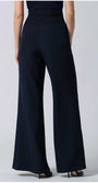 Back view of a woman wearing tailored Greta Wide Leg Pants in Navy with a high waist and wide silhouette