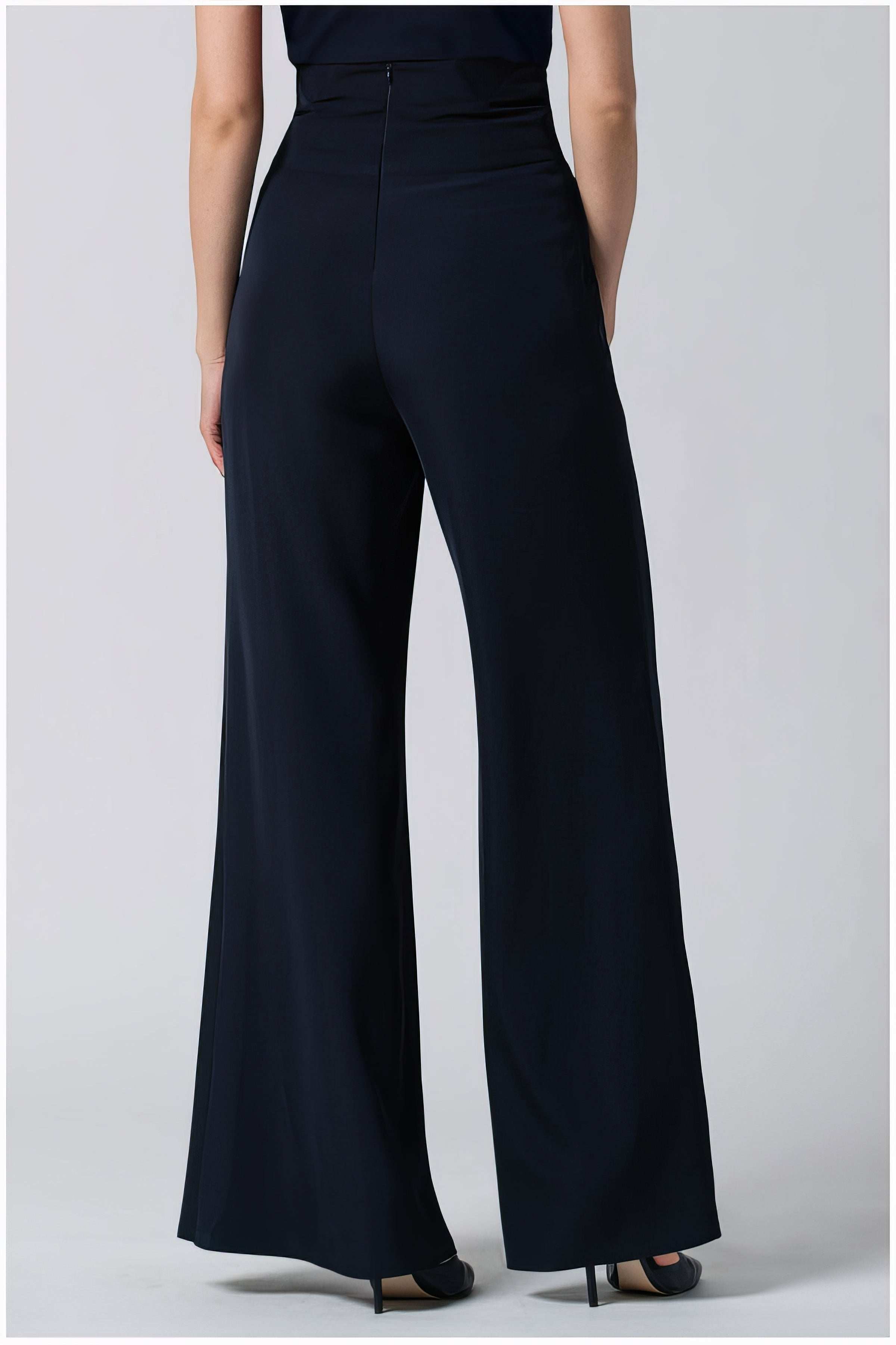 Back view of a woman wearing tailored Greta Wide Leg Pants in Navy with a high waist and wide silhouette