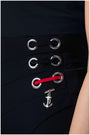 Close-up of black Tailored Wide Leg Pants Greta pants waistband with silver eyelets, red lace detail, and an anchor charm accessory.