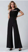 Woman wearing Greta Wide Leg Pants in Black styled with a black top and heels against a plain background