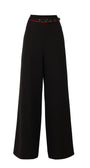 Black wide-leg pants with a red belt on a white background