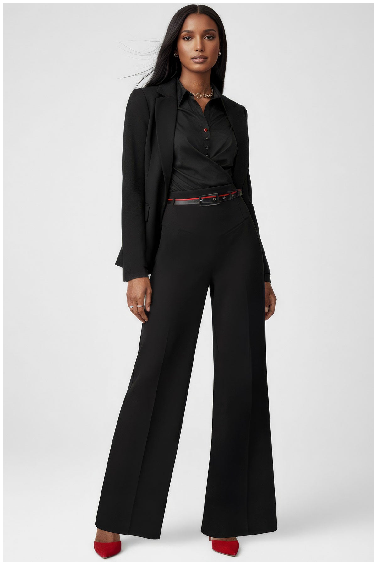 Woman wearing a black suit with red shoes on a white background