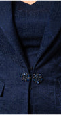 Navy blue patterned coat with decorative buttons on a plain background