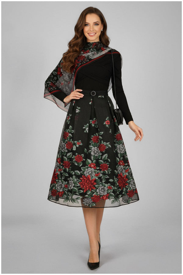 Woman wearing a black dress with floral patterns on a gray background