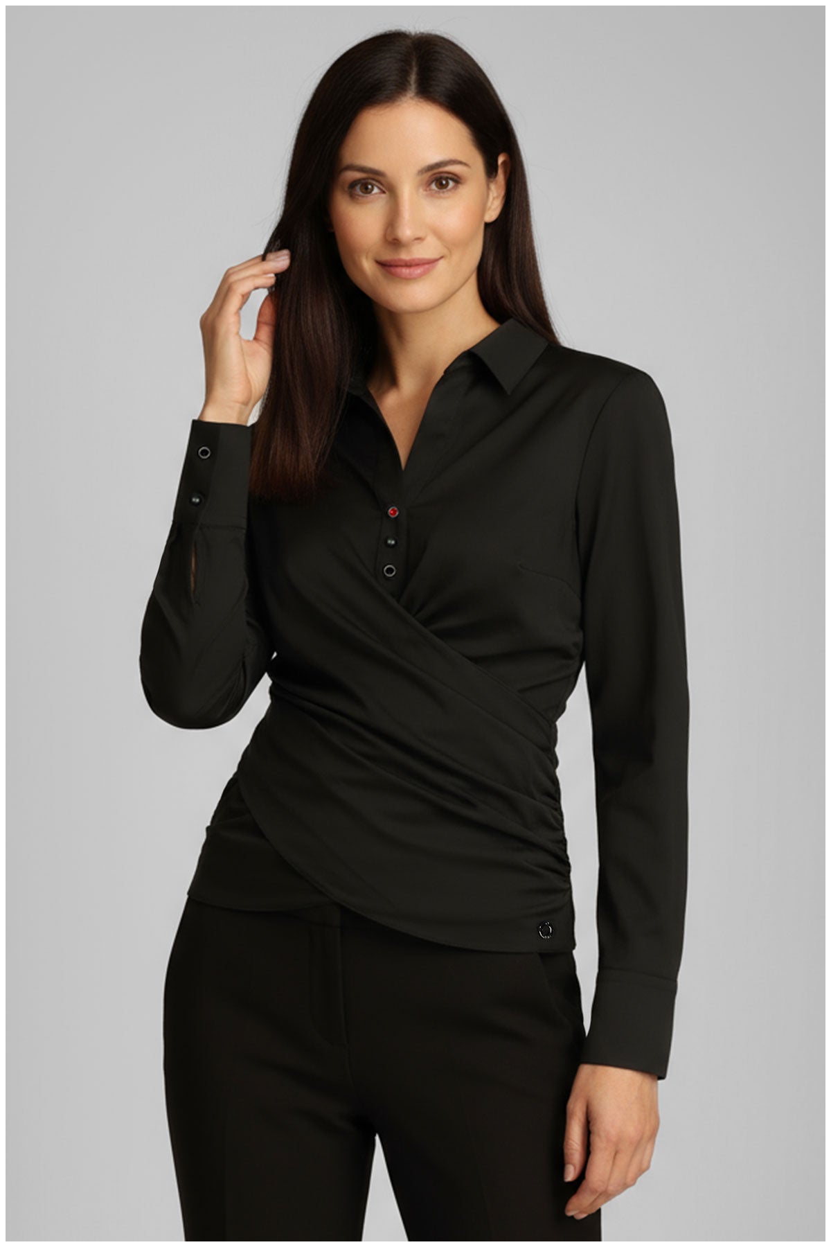 Woman wearing a black shirt and pants on a gray background